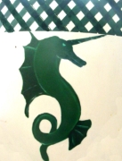 Device: Argent, a unicornate natural seahorse erect to sinister vert, a chief vert fretty argent